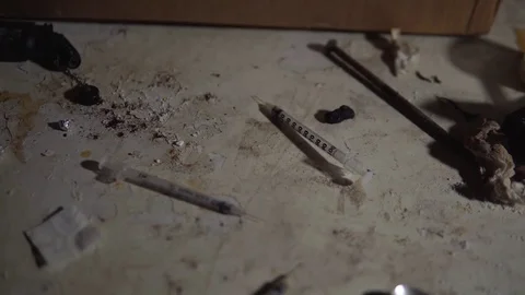 Used Syringes, Needles For Heroin And Fentanyl, Drugs On Dirty Floor Of Slum Stock Footage