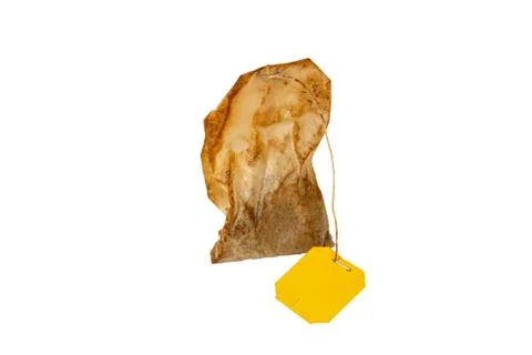 Used tea bag on the white background Stock Photos