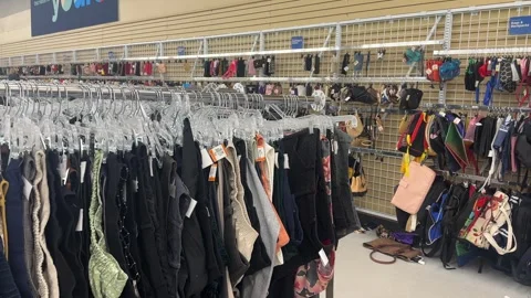 Used Thrift store clothes and items displayed Stock Footage 345966686