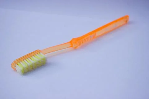 Used toothbrush on gray background Stock Photos