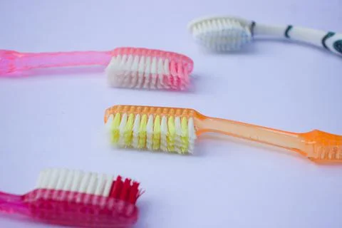 Used toothbrush on gray background Foto stock