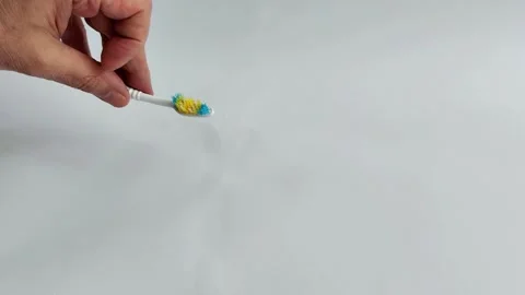 Used Toothbrush on White Background- Aging Hygiene Tool Stock Footage 320042223