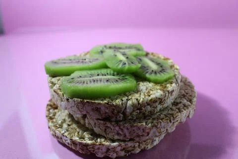 A useful breakfast sandwich with kiwi fruit kind of side with a place for tex Stock Photos