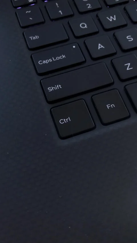 User activates caps lock on laptop keyboard for typing Stock Footage 307135188