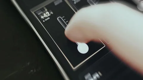 User adjusts a thermometer-like gauge, raising temperature from low to warm Stock Footage 335469936