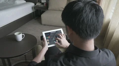 User Analyzing Data on Tablet in Hotel Room Stock Footage 315116087