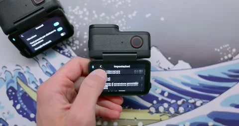 User browses settings menu on action camera flip screen, close up Stock Footage 306933813