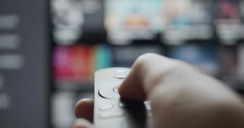 User browsing video streaming content with wireless remote control on a smart tv Stock Footage 135337101