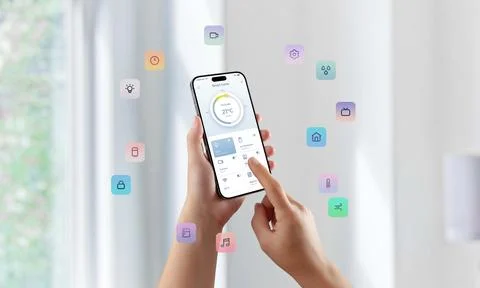 User controlling smart home features with floating colorful icons surrounding Stock Photos