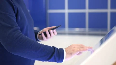 User Engaging and Interacting with a Digital Kiosk at a Modern and Contemporary Stock Footage 296735578