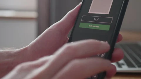 User entering a secret code on a touchscreen smartphone to bypass Stock Footage 335521780
