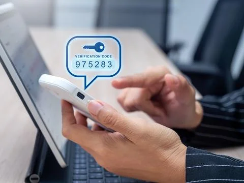 User entering verification code from smartphone for two-factor authenticati.. Stock Photos