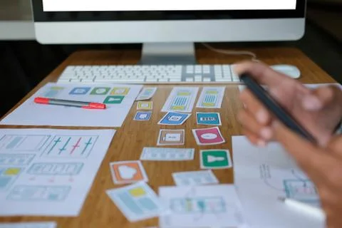 User experience UX designer designing web on smart phone layout. UI developer Stock Photos