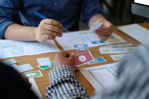 User experience UX designer designing web on smart phone layout. UI developer Stock Photos