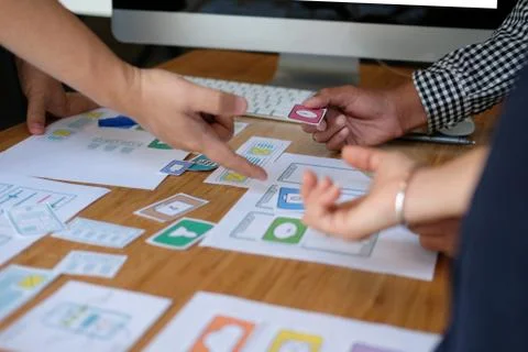 User experience UX designer designing web on smart phone layout. UI developer Stock Photos