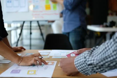 User experience UX designer designing web on smart phone layout. UI developer Stock Photos