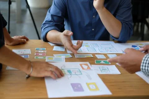 User experience UX designer designing web on smart phone layout. UI developer Stock Photos
