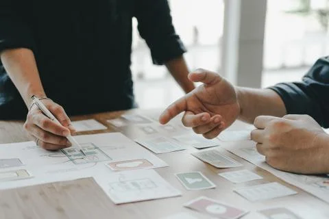 User experience UX designer designing web on smart phone layout. UI developer Stock Photos