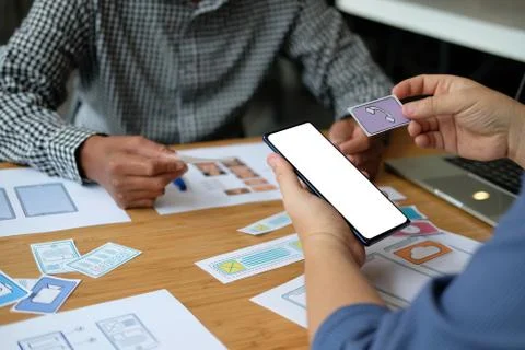 User experience UX designer designing web on smart phone layout. UI developer Stockfoto's