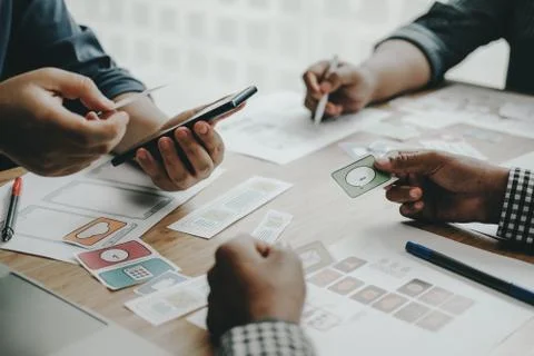 User experience UX designer designing web on smart phone layout. UI developer Stock Photos