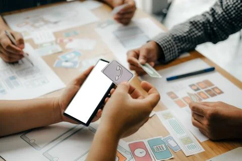 User experience UX designer designing web on smart phone layout. UI developer Stock Photos