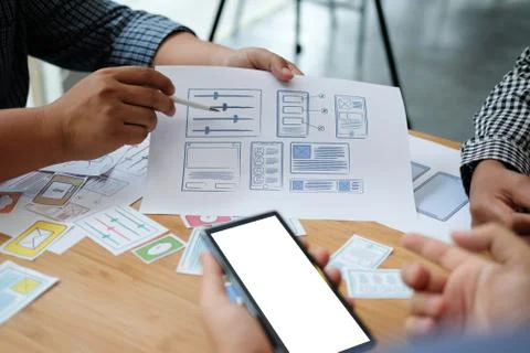 User experience UX designer designing web on smart phone layout. UI developer Stock Photos