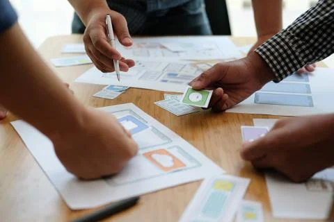 User experience UX designer designing web on smart phone layout. UI developer Stock Photos