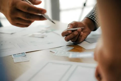 User experience UX designer designing web on smart phone layout. UI developer Stock Photos