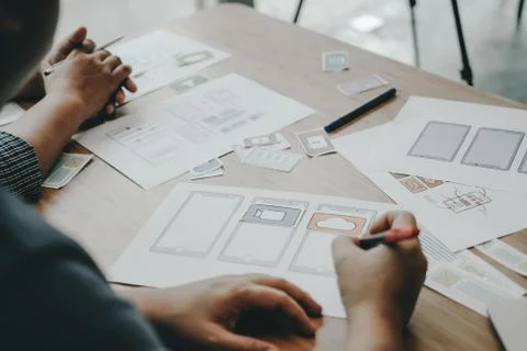User experience UX designer designing web on smart phone layout. UI developer Stock Photos