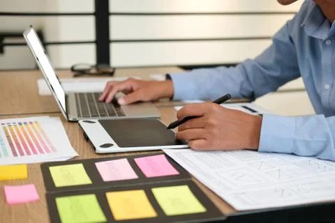 User experience UX designer designing web on smart phone layout. UI developer Stock Photos