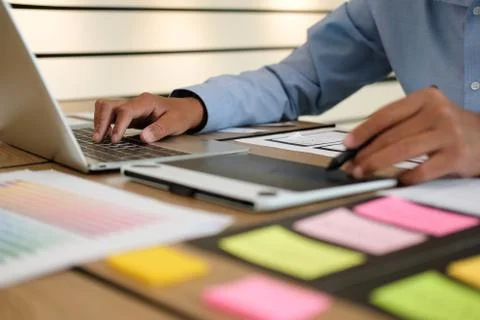 User experience UX designer designing web on smart phone layout. UI developer Stock Photos