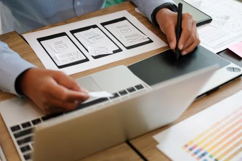 User experience UX designer designing web on smart phone layout. UI developer Stockfoto's