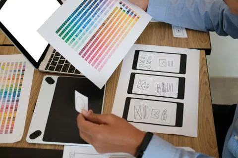 User experience UX designer designing web on smart phone layout. UI developer Stock Photos