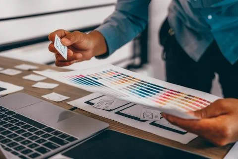 User experience UX designer designing web on smart phone layout. UI developer Stock Photos