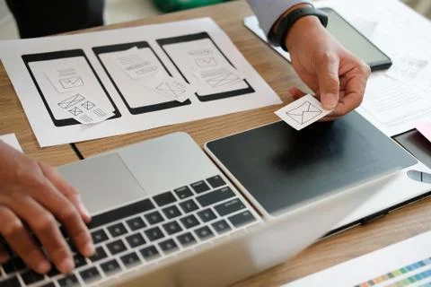 User experience UX designer designing web on smart phone layout. UI developer Stock Photos