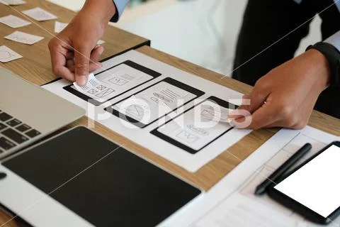 User experience UX designer designing web on smart phone layout. UI developer Stock Photos