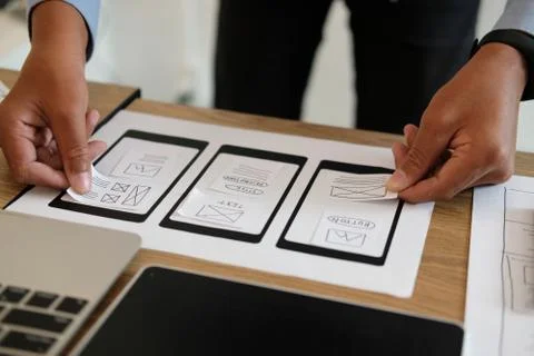 User experience UX designer designing web on smart phone layout. UI developer Stock Photos