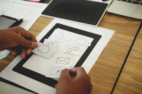 User experience UX designer designing web on smart phone layout. UI developer Stock Photos