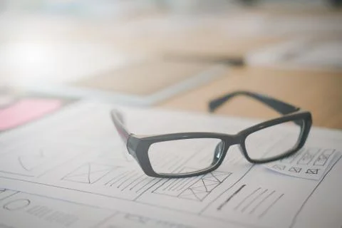 User experience UX designer designing web on smart phone layout. UI developer Stock Photos
