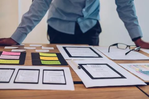 User experience UX designer designing web on smart phone layout. UI developer Stock Photos