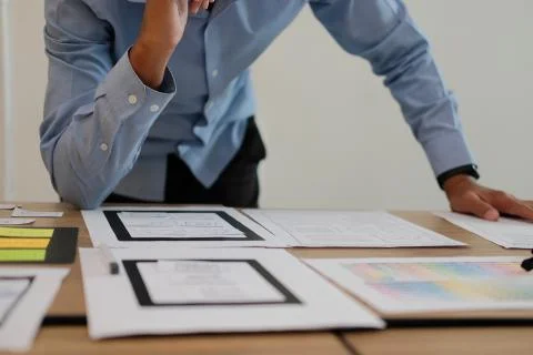 User experience UX designer designing web on smart phone layout. UI developer Stock Photos