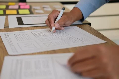 User experience UX designer designing web on smart phone layout. UI developer Stock Photos