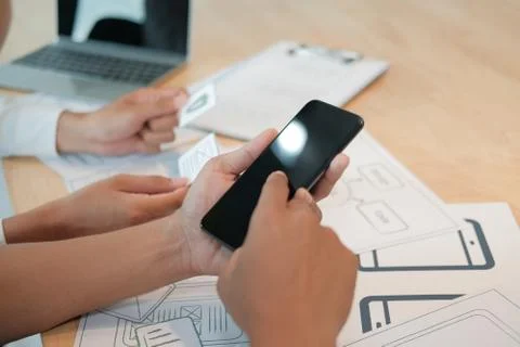 User experience UX designer designing web on smart phone layout. UI developer Stock Photos