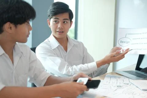 User experience UX designer designing web on smart phone layout. UI developer Stock Photos