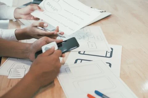User experience UX designer designing web on smart phone layout. UI developer Stock Photos