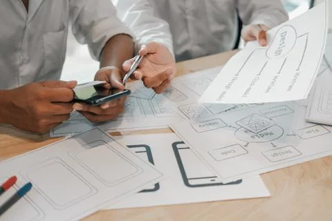 User experience UX designer designing web on smart phone layout. UI developer Stock Photos