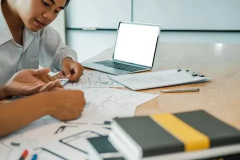 User experience UX designer designing web on smart phone layout. UI developer Stock Photos