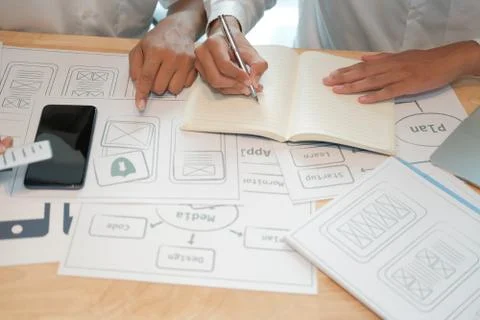 User experience UX designer designing web on smart phone layout. UI developer Stock Photos
