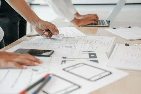 User experience UX designer designing web on smart phone layout. UI developer Stock Photos