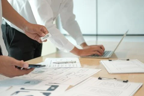 User experience UX designer designing web on smart phone layout. UI developer Stock Photos